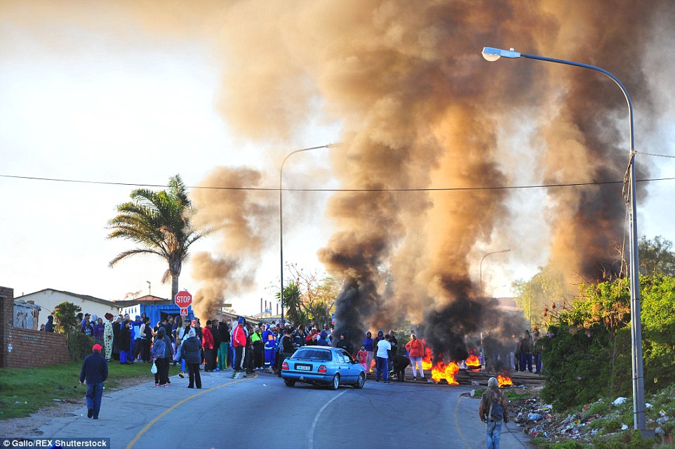 Parents and pupils clashed with officers after blocking roads, burning tyres and throwing petrol bombs in areas across Port Elizabeth