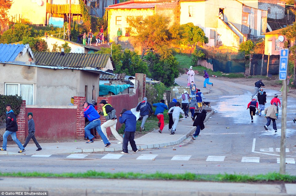 Residents run for cover as police begin to disperse the demonstrations with tear gas, stun grenades and rubber bullets